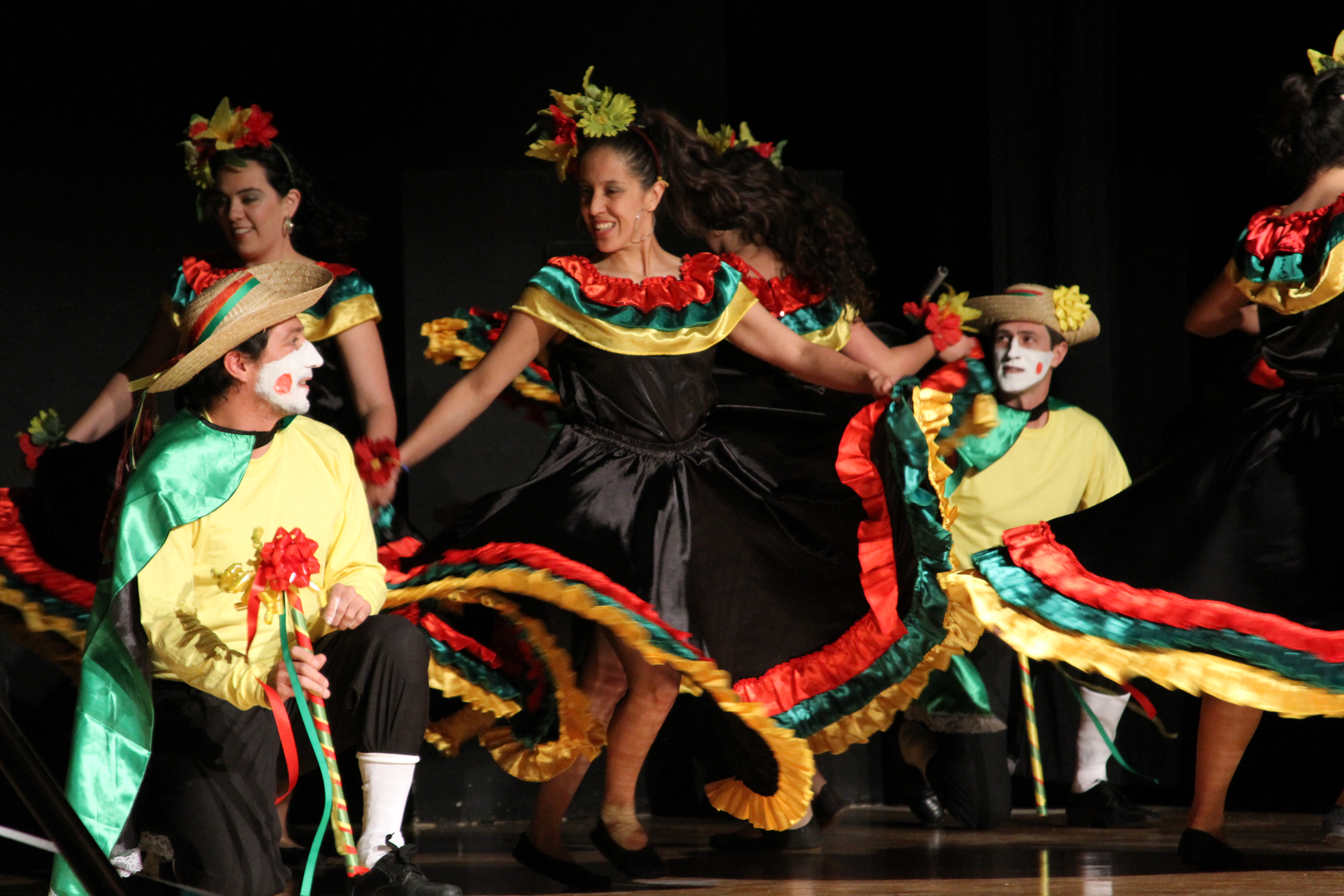 Students dancing on stage at a cultural club performance
