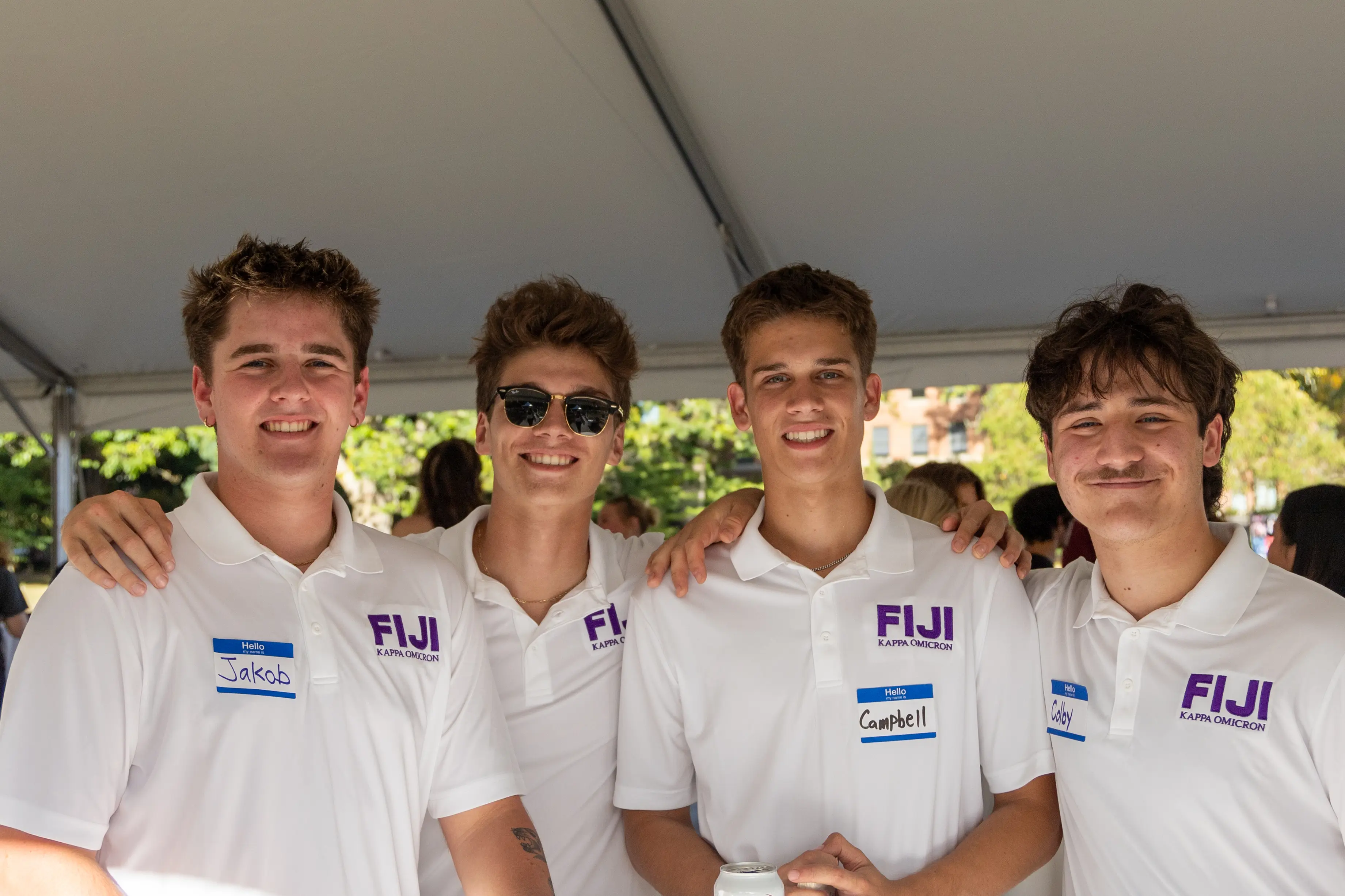 4 fraternity members smiling at the camera
